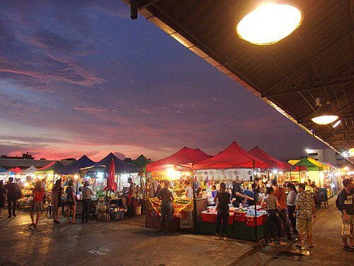 A busy Bangkok night market illuminated after dark