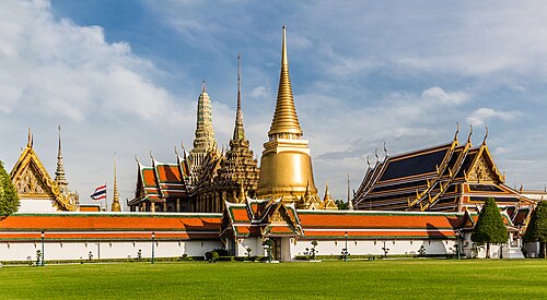 Ornate golden buildings and decorated roofs at Wat Phra Kaew in Bangkok