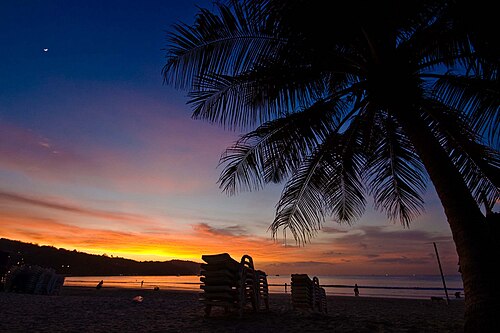 Orange sunset reflected across Patong Beach in Phuket