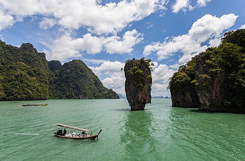 Tall limestone island rising from the water in Phang Nga Bay