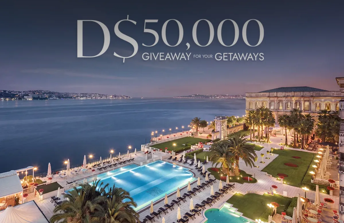 GHA campaign artwork showing a waterfront hotel and pool beneath a D$50,000 giveaway headline.